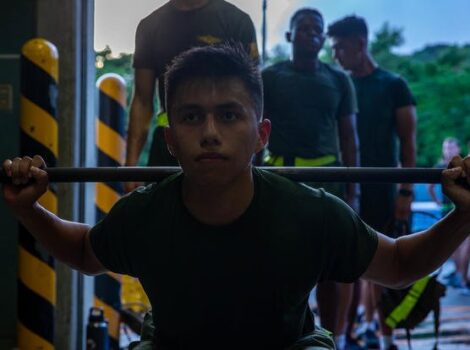 U.S. Marine Corps Lance Cpl. Isai Guevara, an embark specialist with Headquarters and Services Company, 3d Landing Support Battalion, Combat Logistics Regiment 3, 3d Marine Logistics Group, squats during the Lander Trials on Camp Foster in Okinawa, Japan.